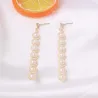 Elegant long golden earrings - geometric metal with pearlsEarrings